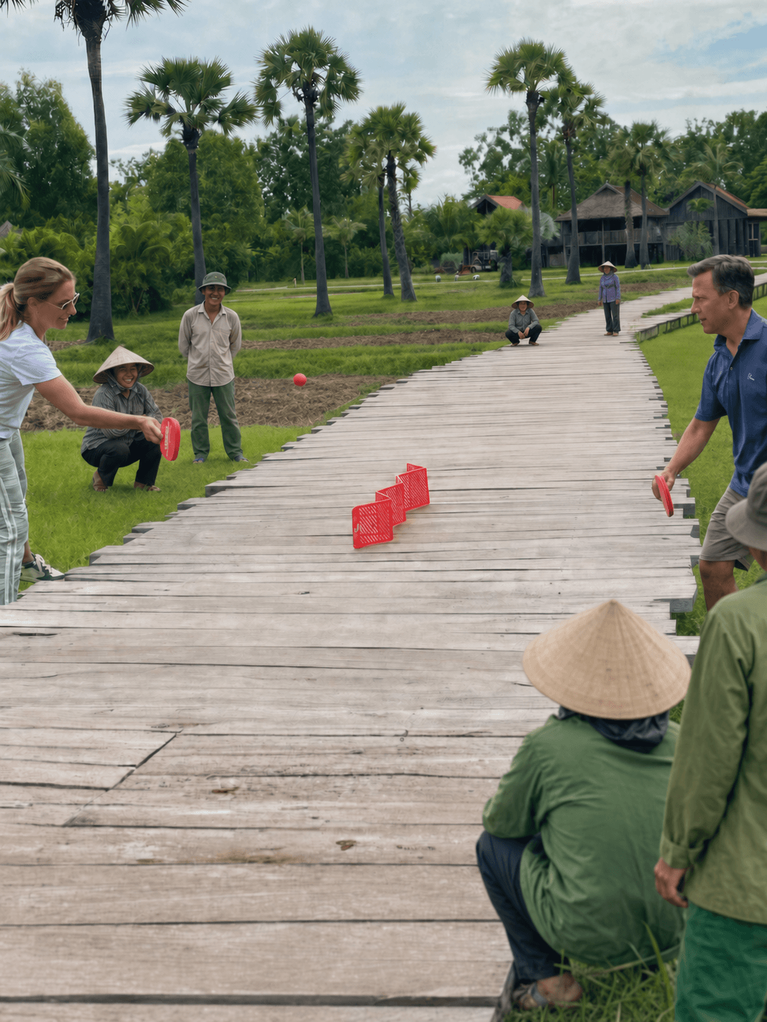 Pepper Pong players turning a wooden walkway through rice fields into a court